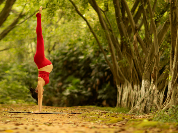 Pregnant woman exercising gently outdoors in natural light during pregnancy