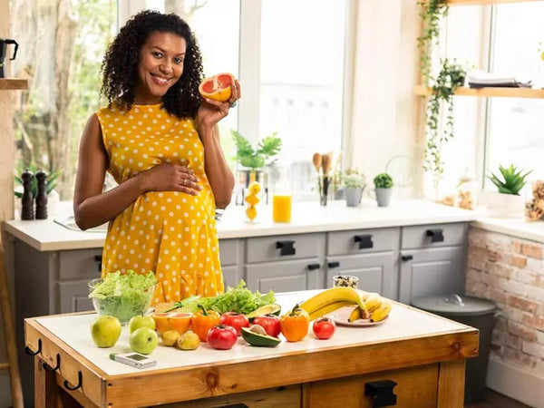 Fresh whole foods including vegetables, fruit and lean protein laid out in a bright kitchen setting
