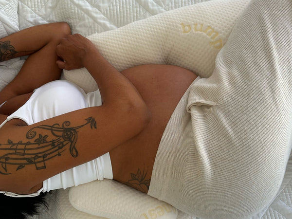 Pregnant woman and partner resting comfortably together in bed with adequate space for both