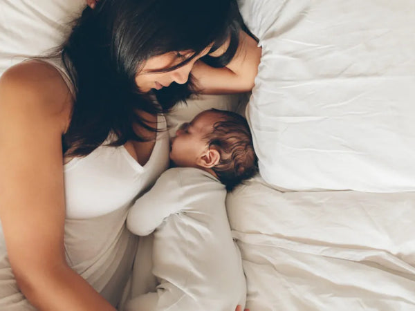 New mother resting at home with her newborn in the early postpartum period