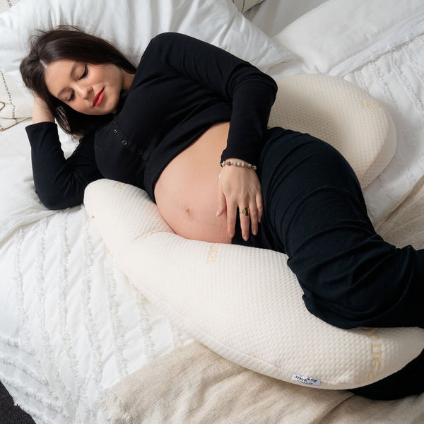 Pregnant woman sleeping comfortably on her side supported by the Bumpnest 3-piece maternity pillow