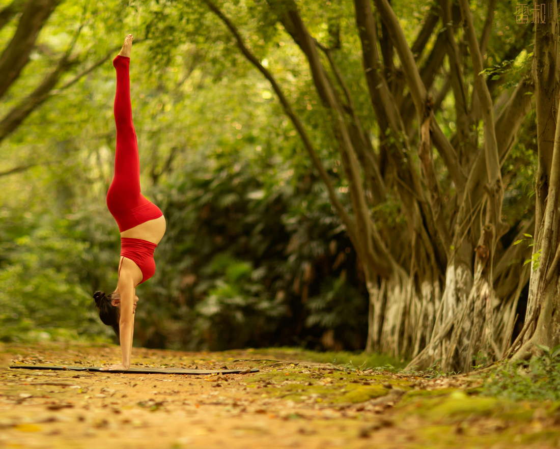 Pregnant woman exercising gently outdoors in natural light during pregnancy