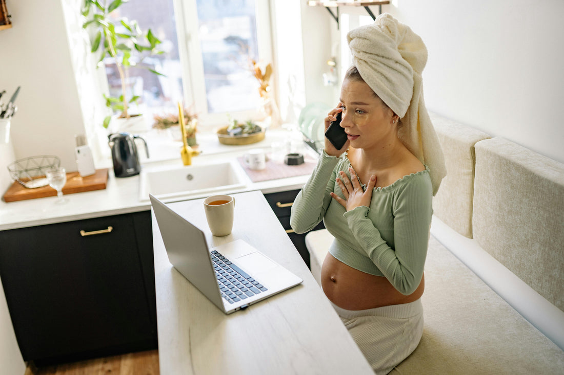 Pregnant woman sitting comfortably at home with hand resting on chest managing heartburn during pregnancy