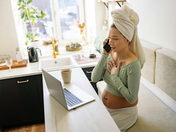 Pregnant woman sitting comfortably at home with hand resting on chest managing heartburn during pregnancy