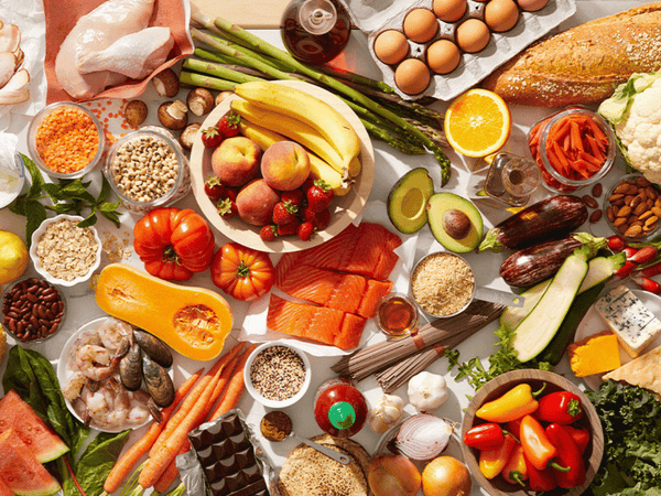 A selection of iron-rich foods including lean meat, lentils, spinach and eggs on a neutral surface
