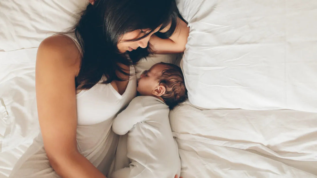 New mother resting at home with her newborn in the early postpartum period