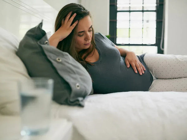 Pregnant woman resting hands on her bump in a calmly