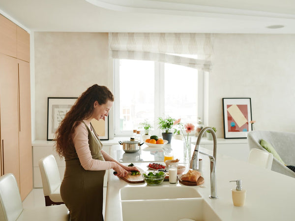 A spread of nutritious whole foods including vegetables, eggs, dairy and fruit on a kitchen surface