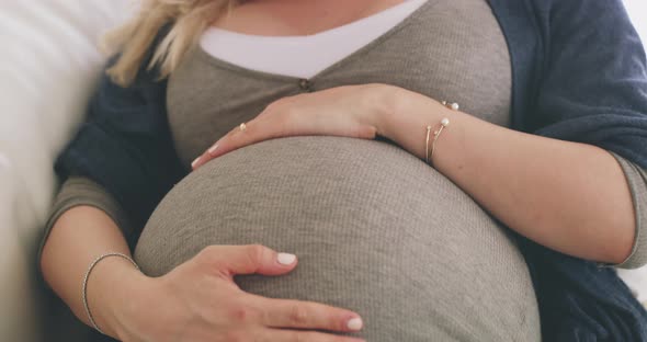 Pregnant woman in late pregnancy resting calmly in preparation for labour