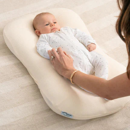 Newborn baby lying in a Bumpnest Baby Pod during supervised awake time in a calm home setting