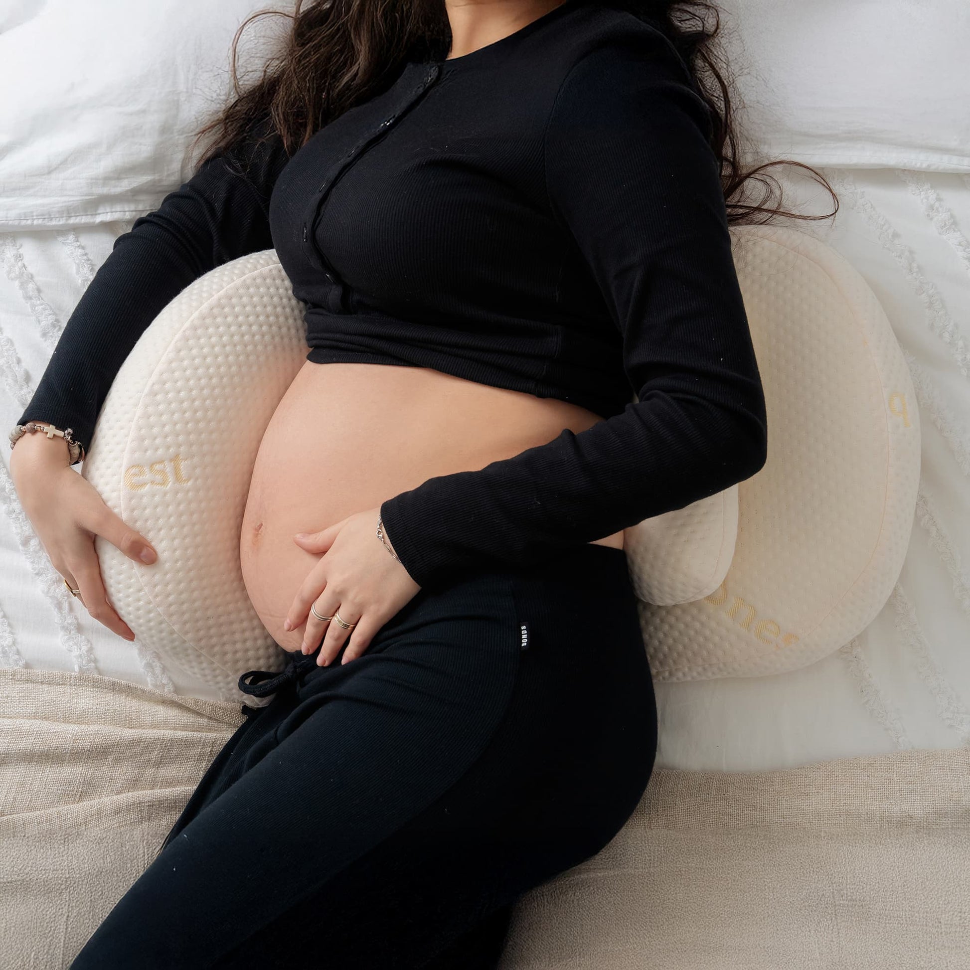 Adjustable Bumpnest maternity pillow expanding with velcro fastening to support growing pregnancy bump