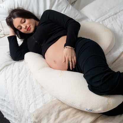 Pregnant woman sleeping comfortably on her side supported by the Bumpnest 3-piece maternity pillow